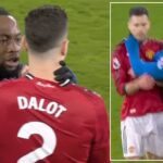 Antoine Semenyo grabbing Diogo Dalot's throat.
