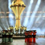 Logo officiel de la CAN 2025 avec un ballon de football et le drapeau marocain