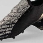 Kith x adidas F50 Spider boot with web-patterned overlay and snakeskin details.