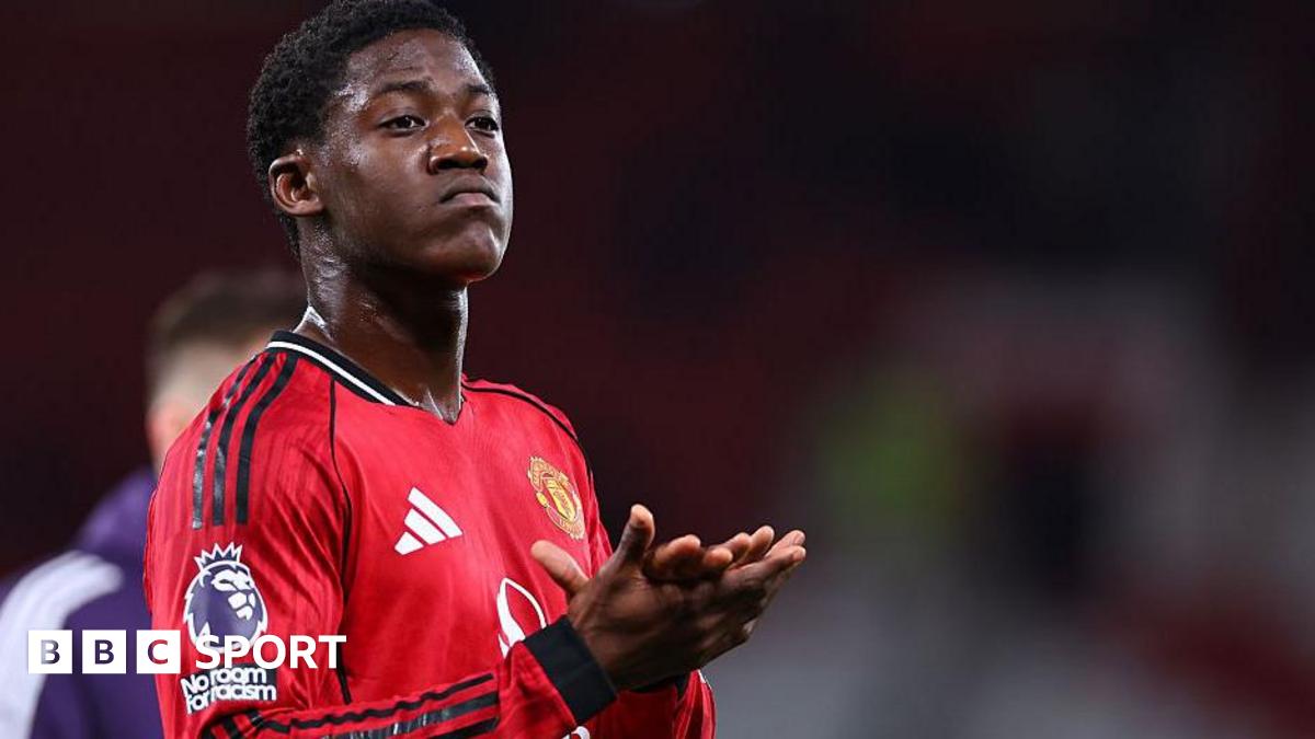 Kobbie Mainoo's half-brother wearing 'Free Kobbie Mainoo' T-shirt during Manchester United vs Bournemouth match.