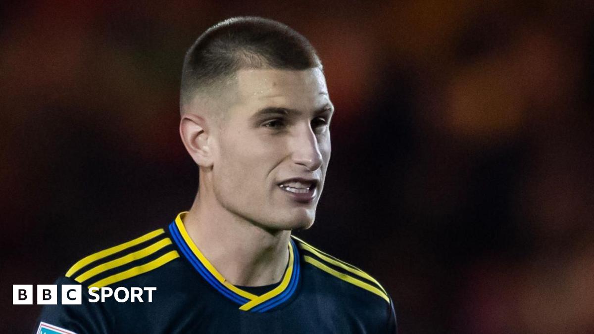 Rhys Bennett speaking to the media, with a caption "Manchester United defender Rhys Bennett shares his message of hope and encouragement"