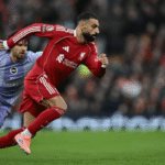 Mohamed Salah celebrating his record-breaking assist with Liverpool teammates.
