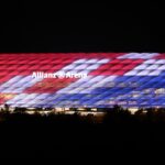 Alt text for the image: "Munich's Allianz Arena at sunset"