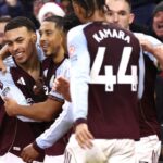 Aston Villa players celebrating a goal at Villa Park.
