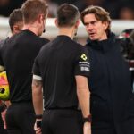 Tottenham Hotspur players reacting to a refereeing decision.