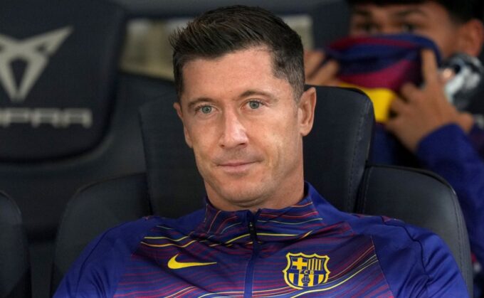 Robert Lewandowski of FC Barcelona looks on from the bench.