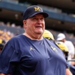 Alt text for the image: Biff Poggi and Michigan Wolverines football team.