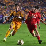 Romulo Zwarg of Tigres battles for possession against Franco Romero of Toluca.