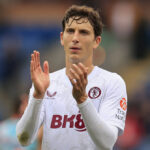 Football players in action on the pitch.