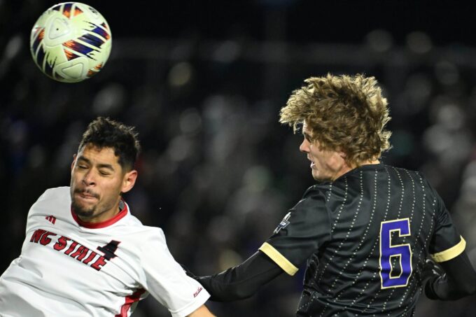 Alt text: Washington Huskies celebrate NCAA men's soccer championship title.
