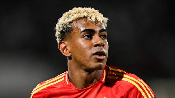 Spain's 2026 World Cup home kit with deep red body, navy sleeves, and yellow pinstripes.