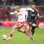 Xaver Schlager running with the ball under pressure from Robin Koch.